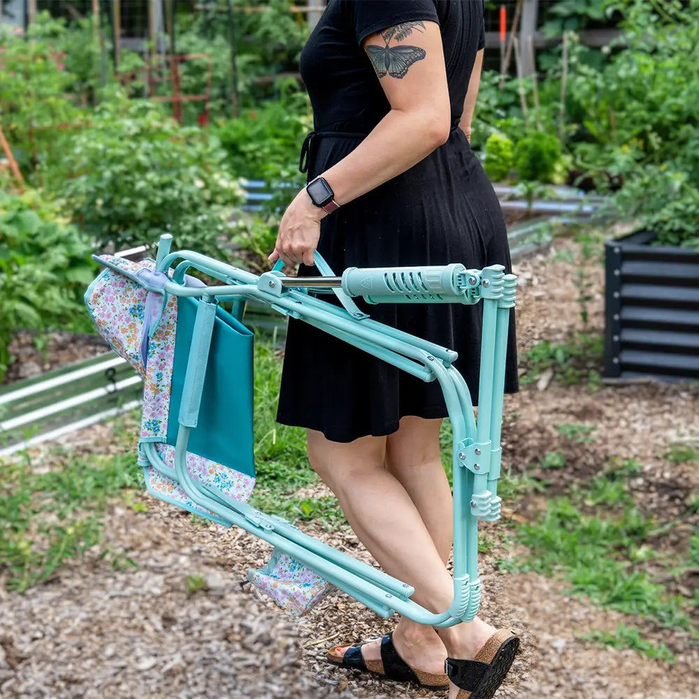 A woman carrying a teal sundress freestyle rocker elite with the integrated carry handle.