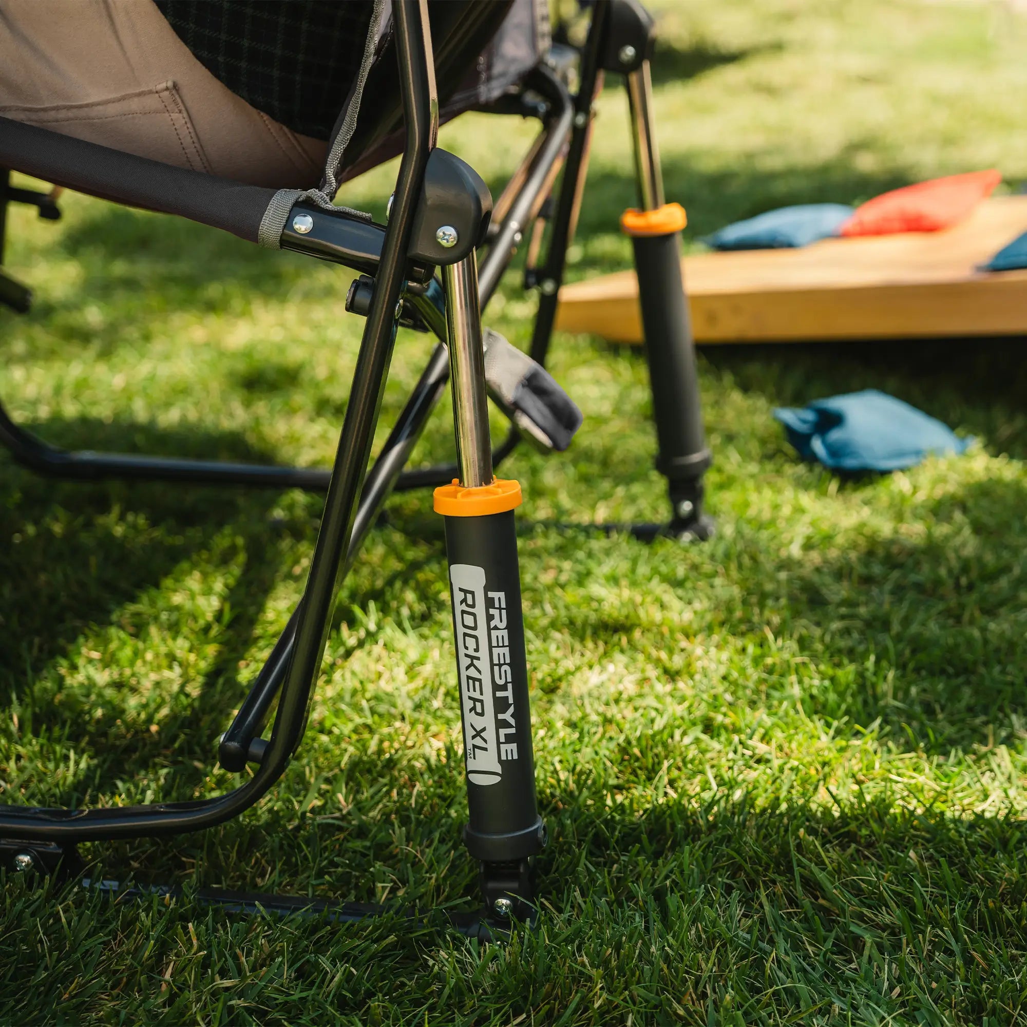 Up-close of the spring action rocking technology on a black freestyle rocker with side table.