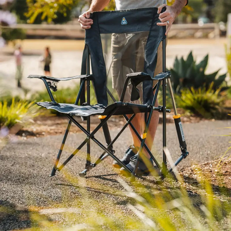 Partially opened Heathered Charcoal Comfort Pro Rocker XL chair being set up outdoors.