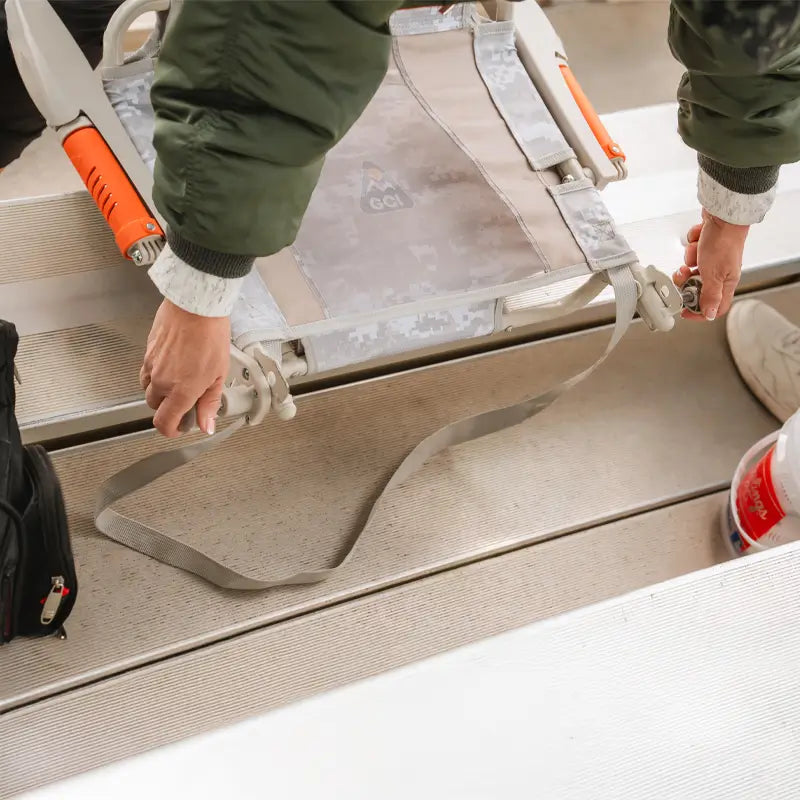 Close-up of Snow Camo Stadium Rock-Cliner being positioned and secured to bleacher.