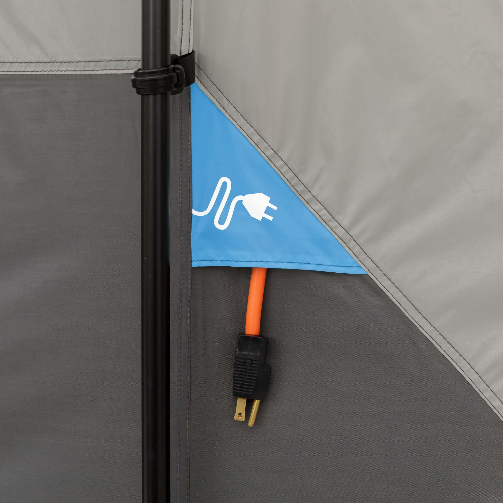 Close-up of CORE 10 person lighted instant cabin tent electrical cord access port with weather flap for outdoor power hookup.
