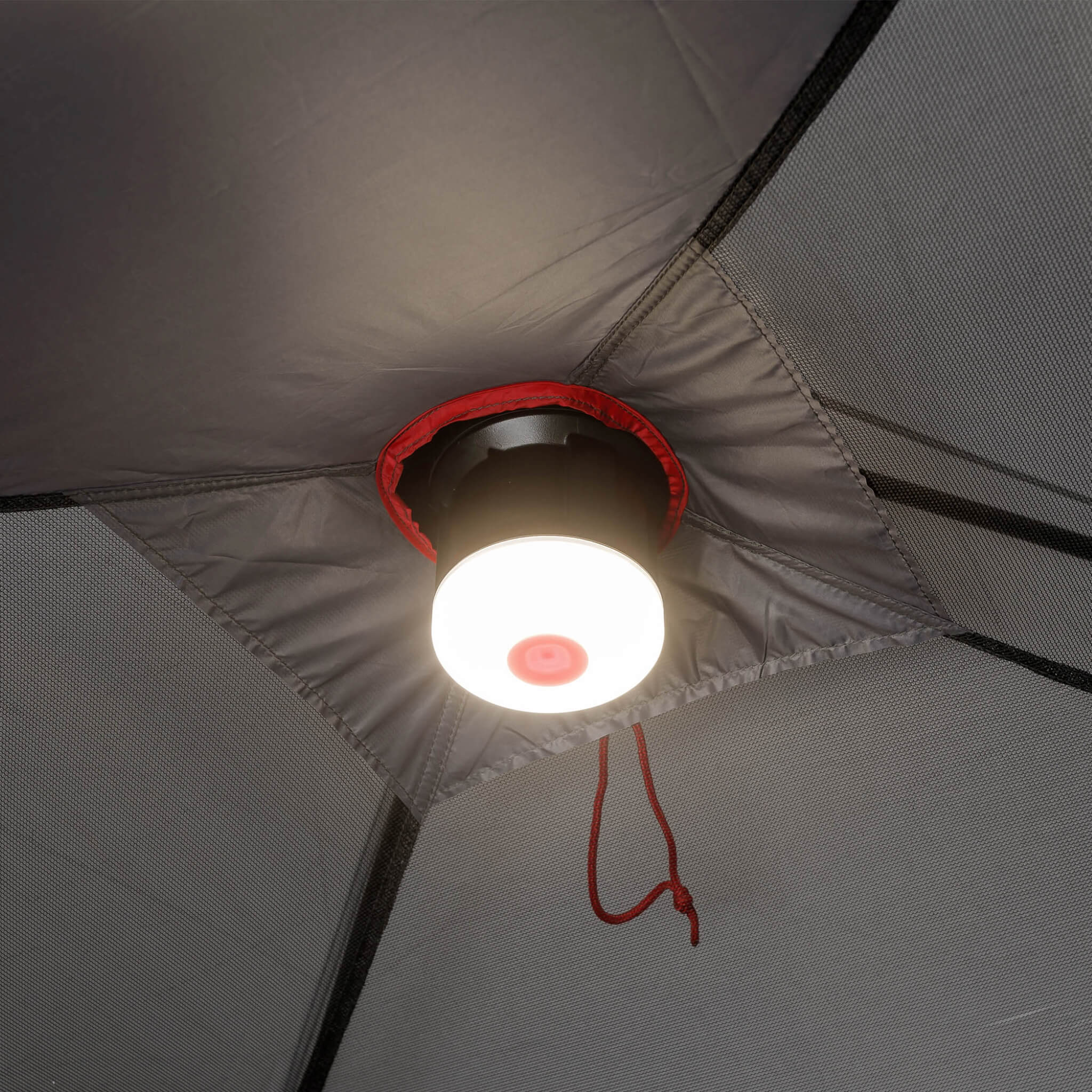 Close-up of CORE 6 person lighted dome tent ceiling light in gray with red accents, shown attached to center hub for even interior illumination.